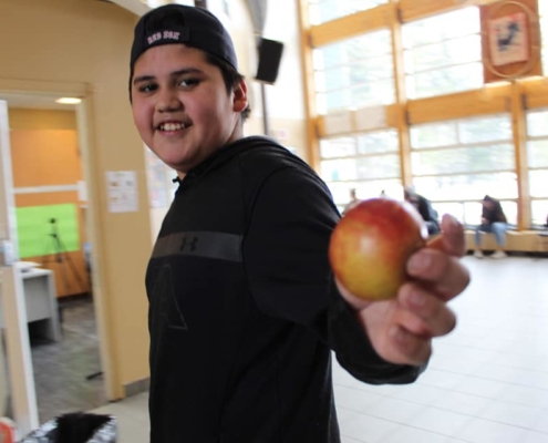 Child holding an apple