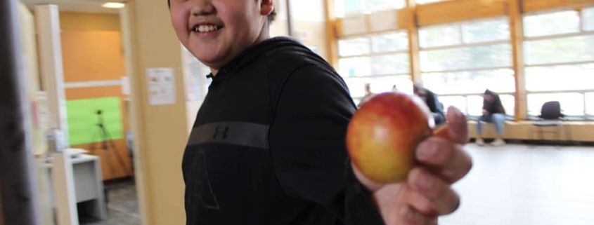 Child holding an apple