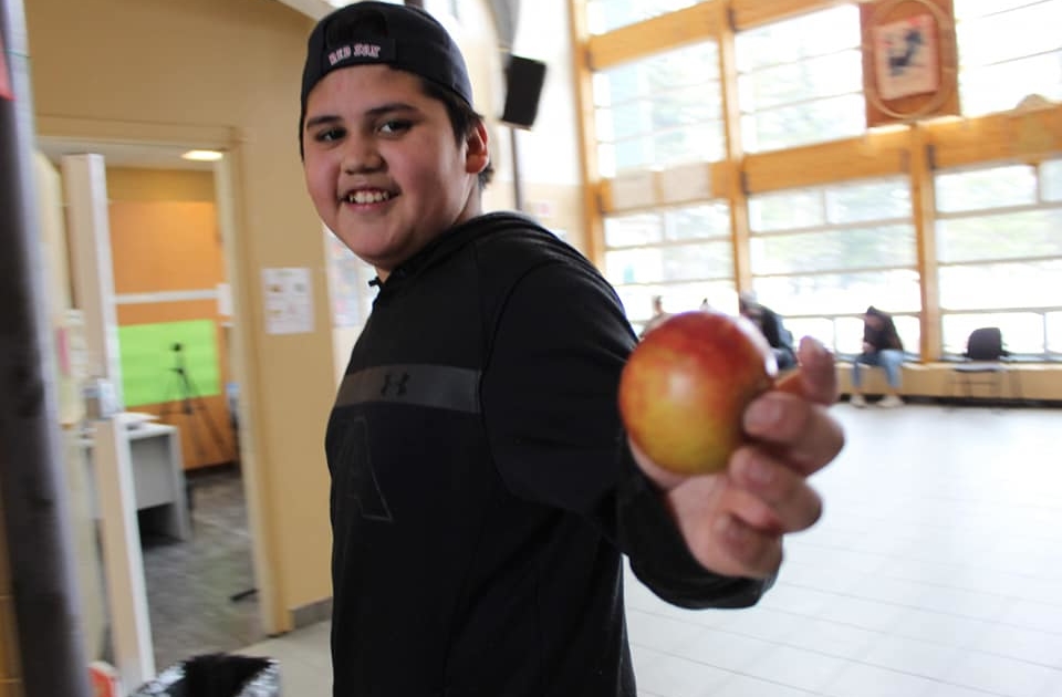 Child holding an apple