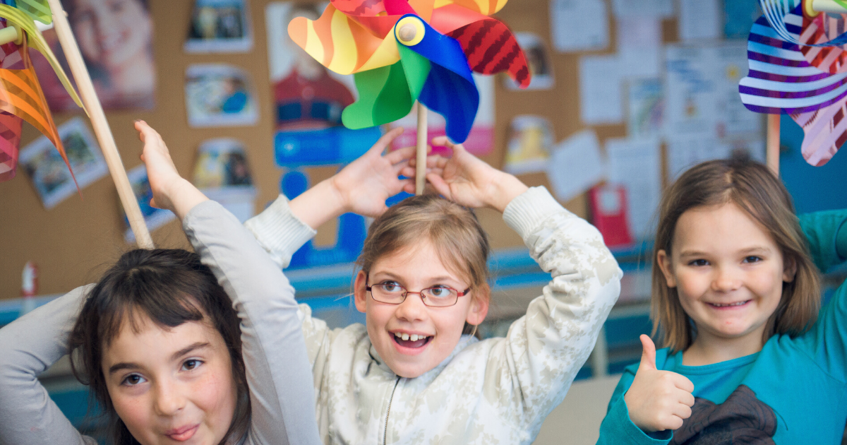 children with pinwheels on their heads