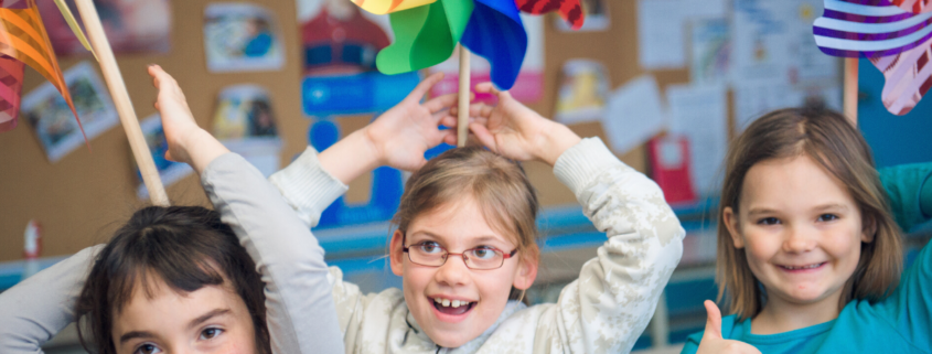 children with pinwheels on their heads