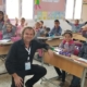 Breakfast club of canada man kneeling in a classroom in Tunisia