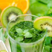 Green smoothy in a glass with kiwi garnish o