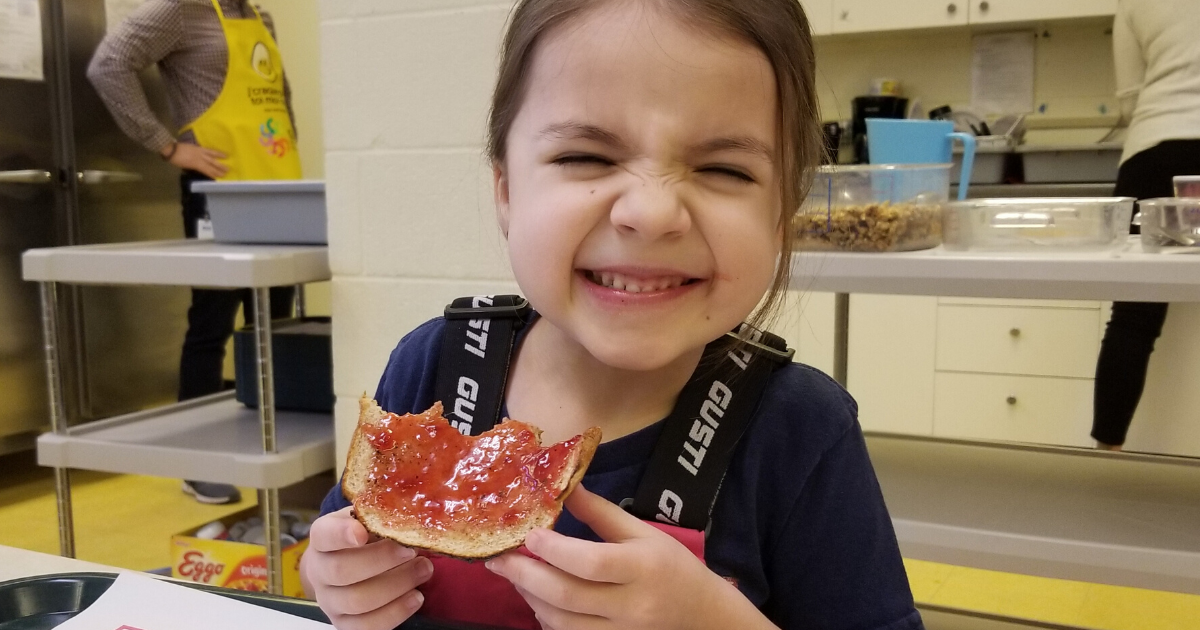 Girl eating toast with jam