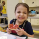 Girl eating toast with jam