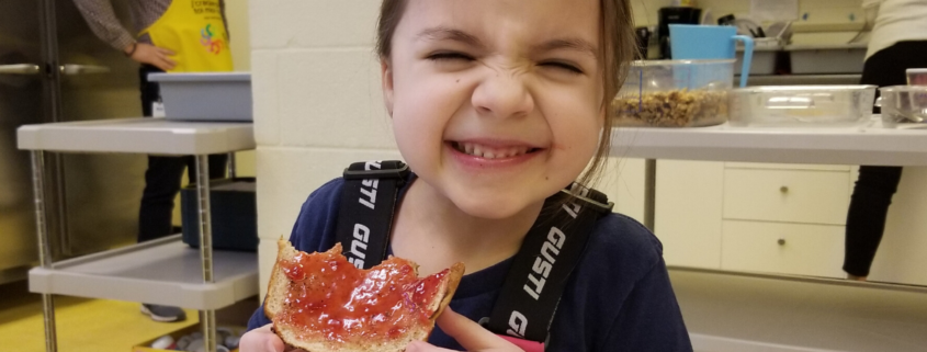 Girl eating toast with jam