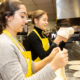 2 young women making pitas in a kitchen