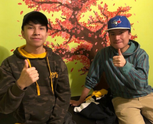 Two teens giving a thumbs up
