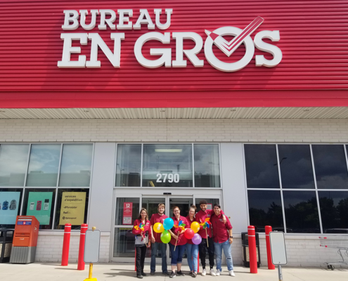 Bureau En Gros employees standing in front of their store