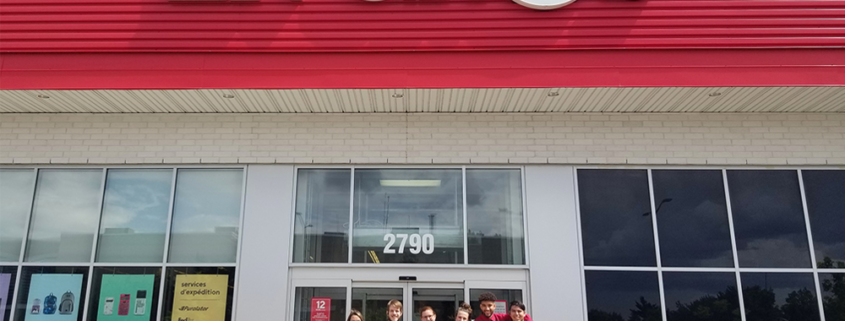 Bureau En Gros employees standing in front of their store