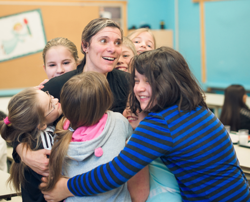 Children hugging a woman