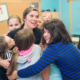 Children hugging a woman