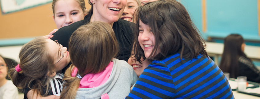 Children hugging a woman