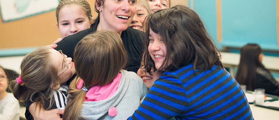 Children hugging a woman