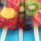 5 fruity popsicles with a mix of fruits in them on a light blue background