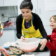 Volunteers with child making breakfast