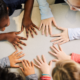 Kids putting hands together on the table