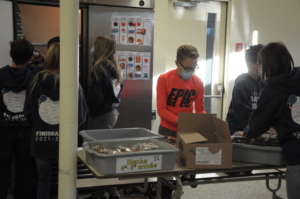 Student serving breakfast