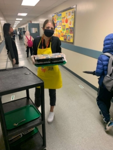 Volunteer serving breakfast