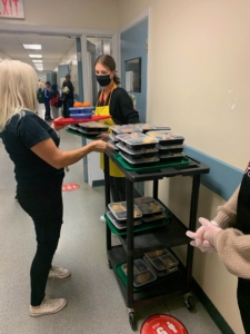 Volunteer serving breakfast