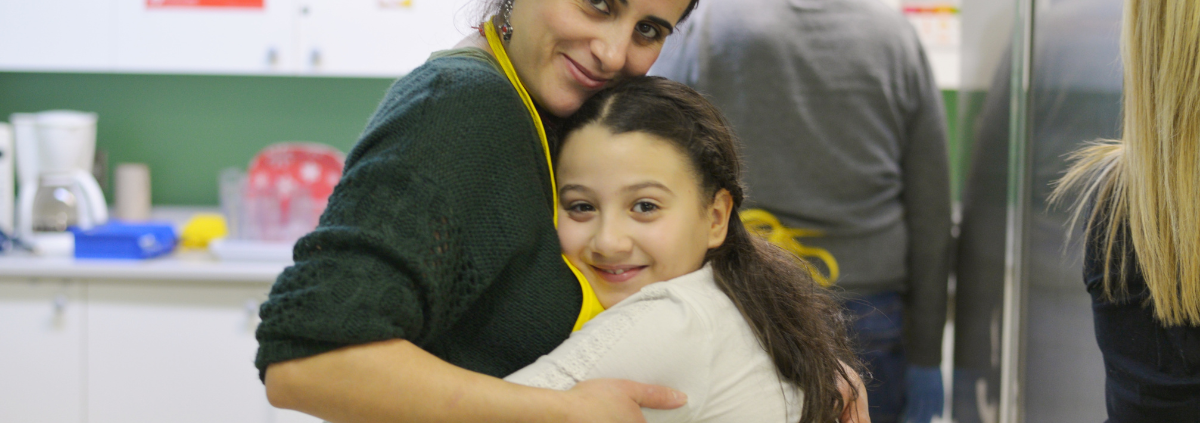 volunteer and student hug