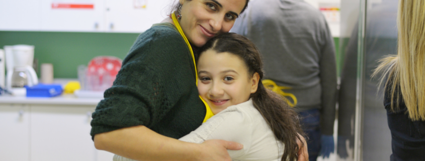 volunteer and student hug