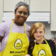 Volunteer and young volunteer in kitchen
